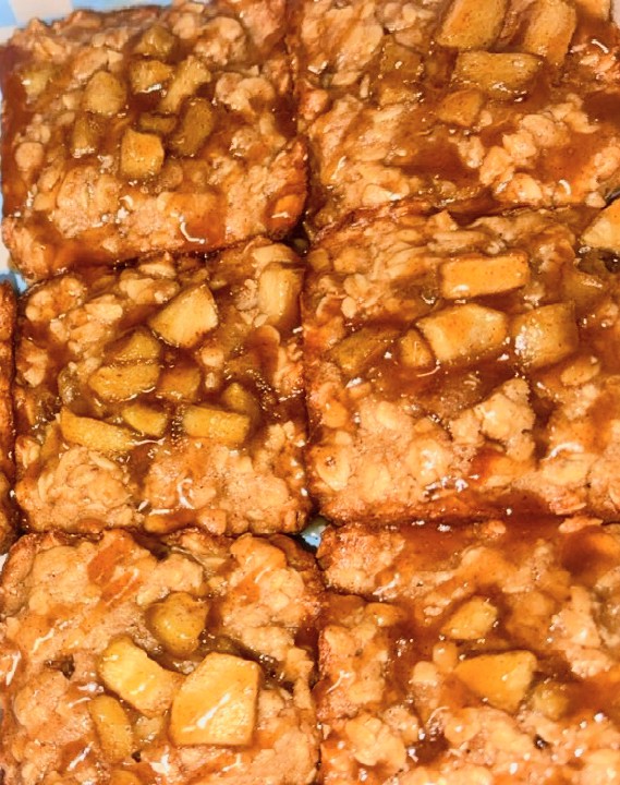 A group of Apple Oat cookies topped with apple pieces and drizzle